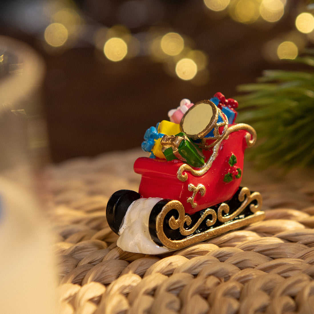 Miniature sleigh filled with gifts, hand-painted wax figure in Southlake Gifts Christmas Candle, holiday décor and gift idea