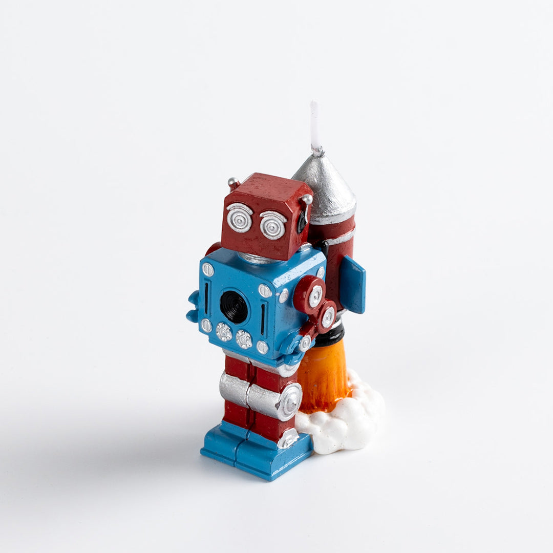 Vintage Robot Rocket Candle Cake Topper in cube shape and retro blue and red color, carring a rocket with flame in the back in the white back ground. 