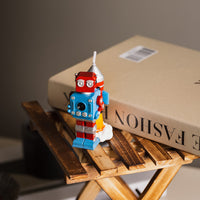 Close-up of Southlake Gifts Vintage Robot Rocket Candle in red, blue, and silver tones, inspired by 1960s tin robots — a unique handmade candle and collectible home décor, ideal for gifting to vintage lovers