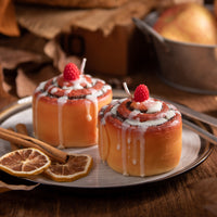 Two cinnamon roll candles from Southlake Gifts are sitting in the plate as food decor candle 