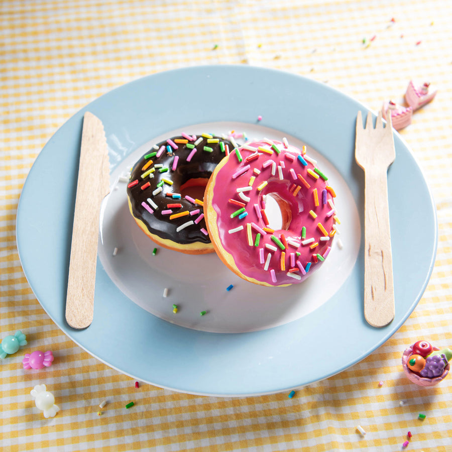 Overhead view of Southlake Gifts doughnut candle, chocolate-scented handmade food candle with sprinkles. Unique centerpiece and novelty décor gift.