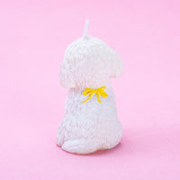 Back of details of Maltese Puppy Candle with a yellow ribbon.