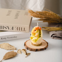 Escape to a different place with this Dinosaur Baby Candle.
