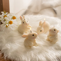Southlake Gifts Blushing Bunny Candle set featuring four handmade unscented bunny candles in different poses, styled on soft white fur with daisies, perfect for Easter decor, table decoration, cake toppers, and cute animal gift ideas.