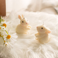 Southlake Gifts Blushing Bunny Candle featuring Looking Up and Looking Right poses, handmade unscented rabbit candles styled with spring daisies, perfect for Easter table decor, cake toppers, nursery styling, and cute animal gifts.