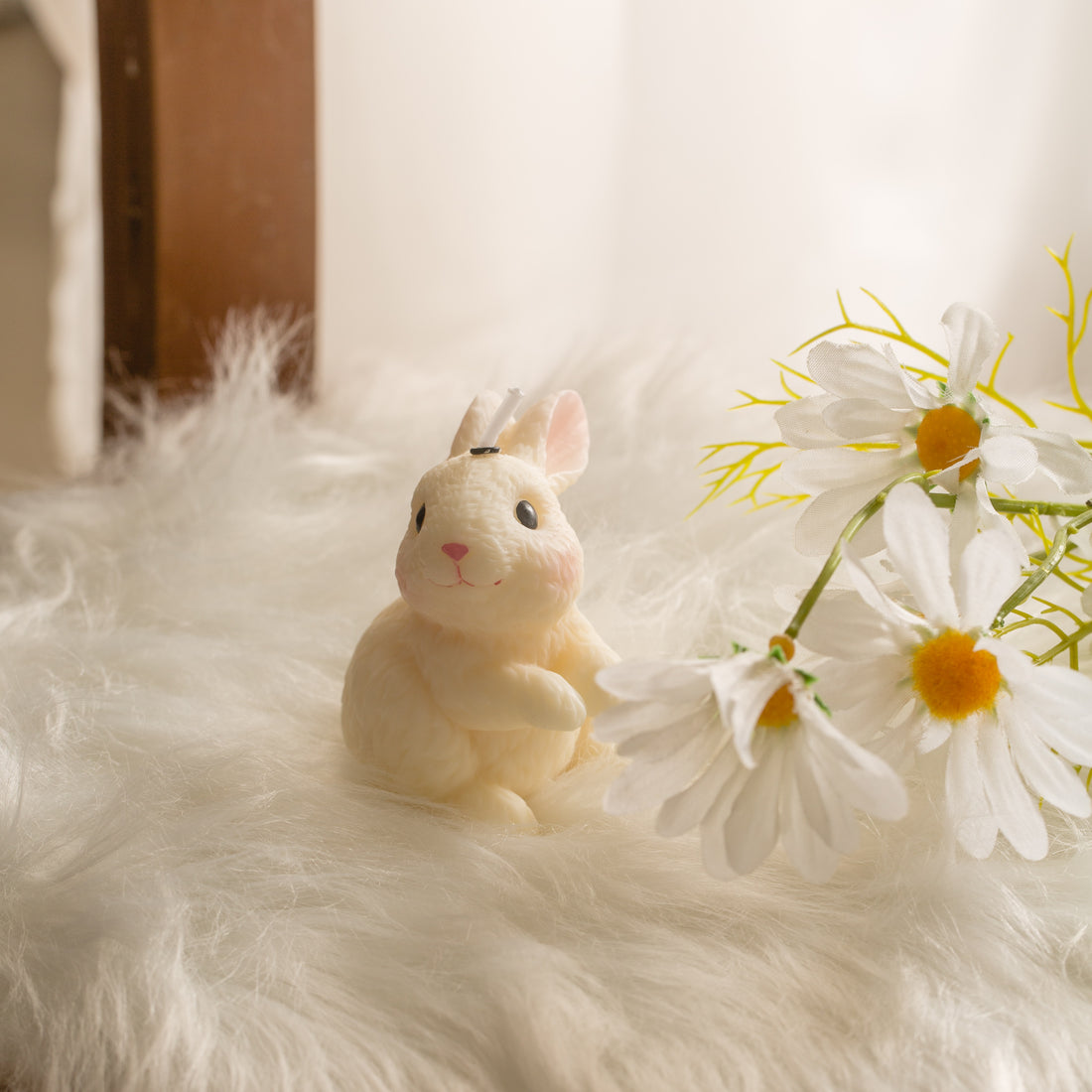 Blushing Bunny Looking Right unscented rabbit candle on soft fur with spring flowers, cute Easter decoration for table styling and seasonal home decor