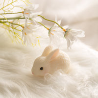 Blushing Bunny Lying Down rabbit candle styled with spring florals, soft ivory Easter decoration for dessert tables and pastel home accents