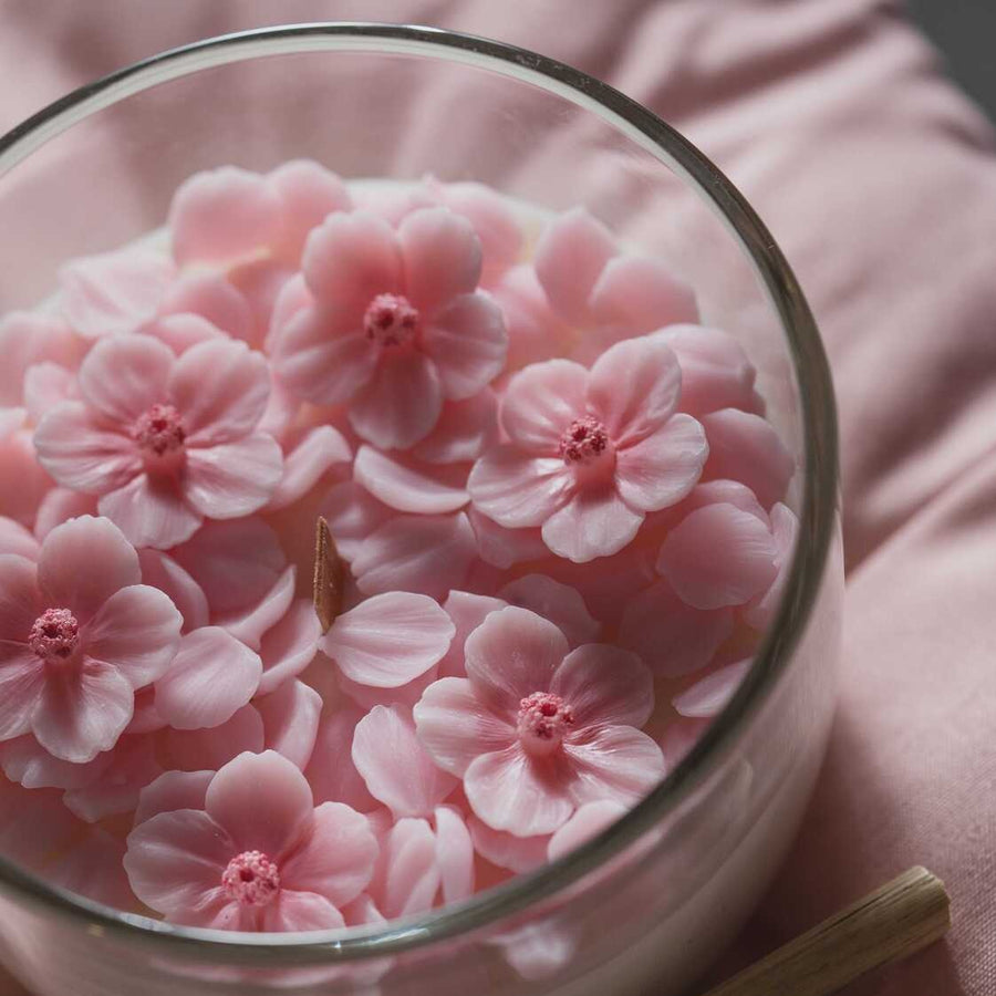 Top-view of Southlake Gifts Sakura Cup Candle showing delicate pink wax cherry blossoms in a glass cup, a realistic handmade candle perfect for gifting and home decoration.