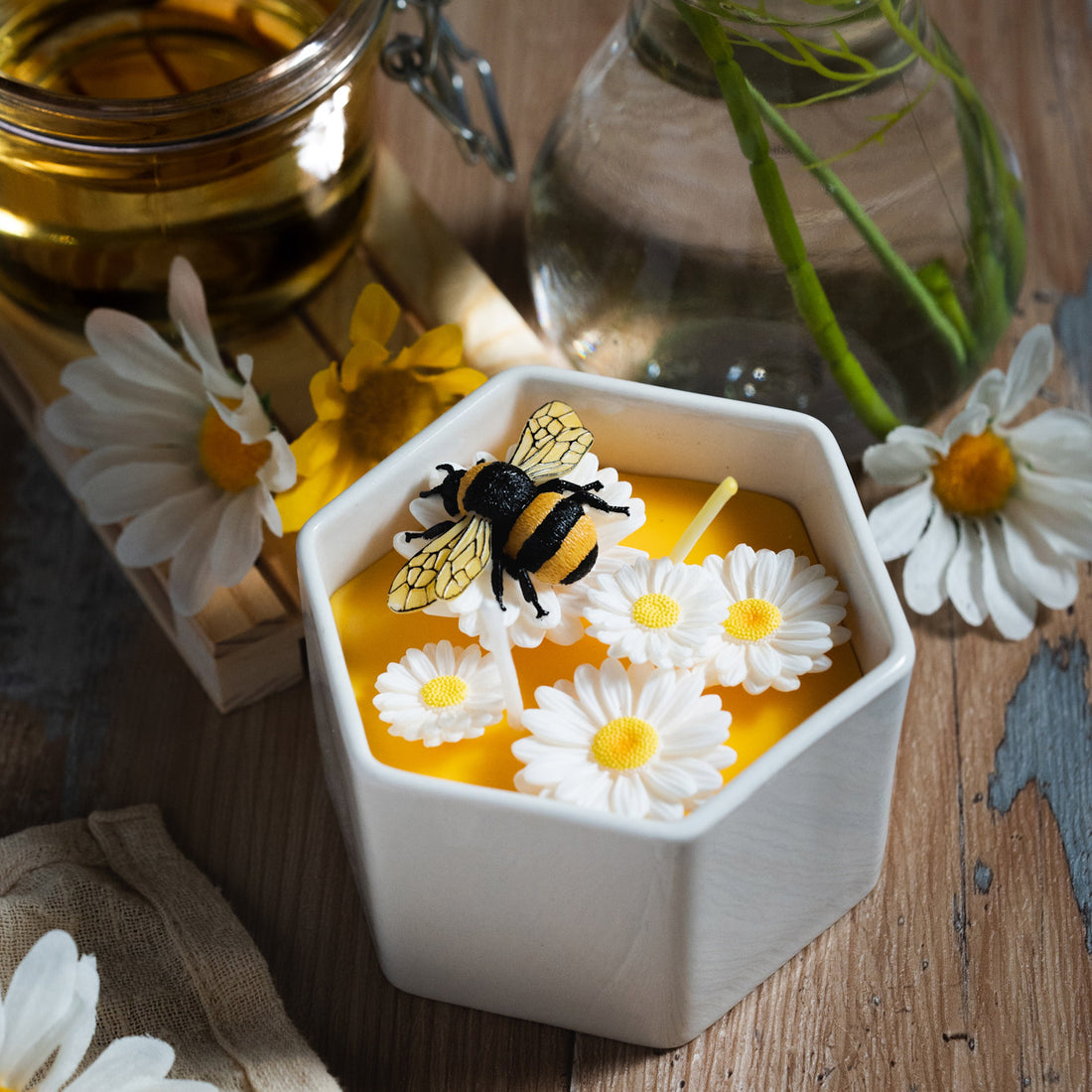 Daisy Beehive Candle Bowl lit with twin flames, showing intricate floral and bee details in honey-colored wax — a cozy handmade candle ideal for home décor and gift giving.