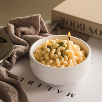 Southlake Gifts Macaroni & Cheese Pasta Candle lit on a table — a realistic handmade food candle that looks just like creamy mac and cheese, perfect for gifting during holidays or for mac and cheese lovers.